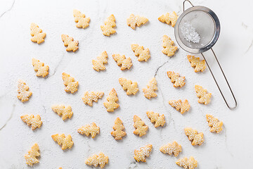 Image showing Homemade Christmas cookies in Christmas tree shape on marble background