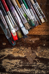 Image showing Artist vintage paint brushes on wooden background