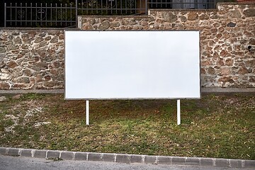 Image showing Empty singboard by a road