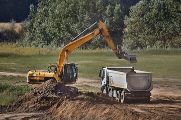 Image showing Construction site excavator and truck