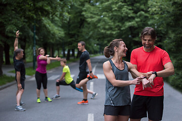 Image showing sporty couple using smart watches