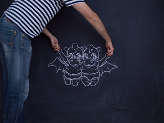 Image showing future dad drawing his imaginations on chalk board