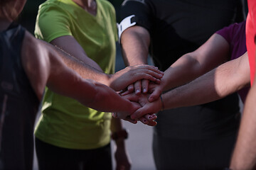 Image showing runners giving high five to each other