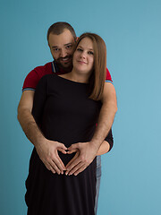 Image showing pregnant couple  isolated over blue background