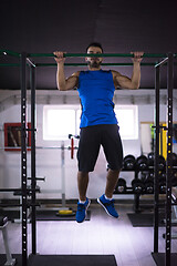 Image showing man doing pull ups on the horizontal bar