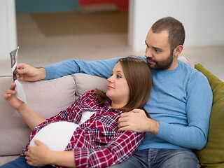 Image showing pregnant couple looking baby\'s ultrasound