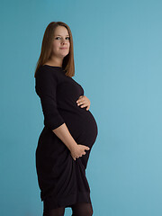 Image showing Portrait of pregnant woman over blue background