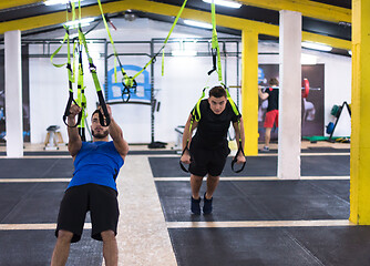 Image showing men working out pull ups with gymnastic rings