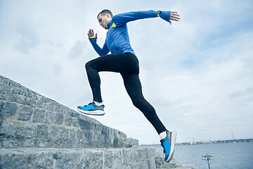 Image showing Man running on city background at morning.