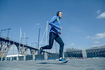 Image showing Man running on city background at morning.