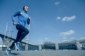 Image showing Man running on city background at morning.