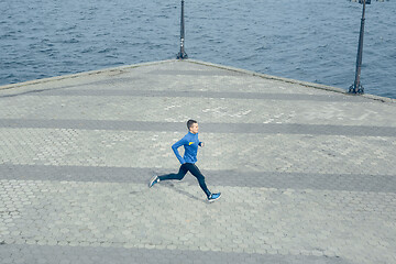 Image showing Man running on city background at morning.