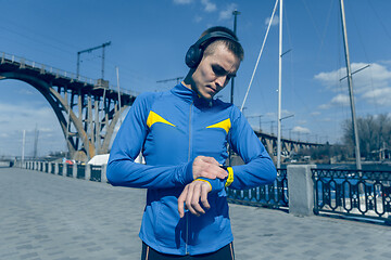 Image showing Man on city background at morning. Healthy lifestyle concept.