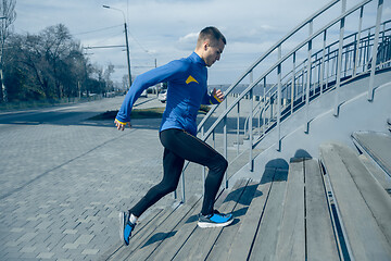 Image showing Man running on city background at morning.