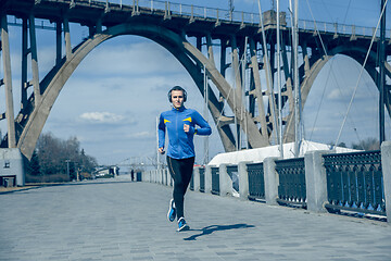 Image showing Man running on city background at morning.