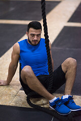 Image showing man relaxing before rope climbing