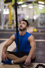 Image showing man relaxing before rope climbing