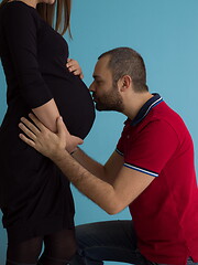 Image showing pregnant couple  isolated over blue background