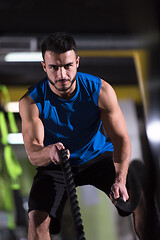 Image showing athlete man doing battle ropes cross fitness exercise