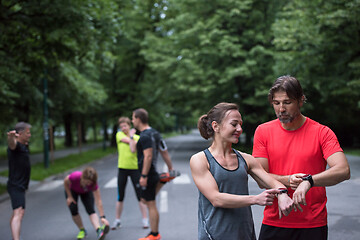 Image showing sporty couple using smart watches