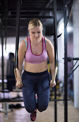 Image showing woman working out pull ups with gymnastic rings