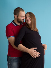 Image showing pregnant couple  isolated over blue background