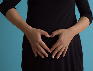 Image showing Portrait of pregnant woman over blue background