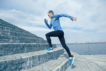 Image showing Man running on city background at morning.