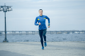 Image showing Man running on city background at morning.