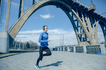 Image showing Man running on city background at morning.