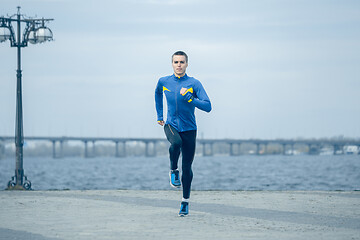 Image showing Man running on city background at morning.