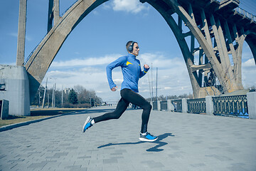 Image showing Man running on city background at morning.