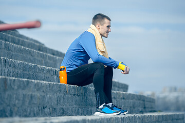 Image showing Man on city background at morning. Healthy lifestyle concept.