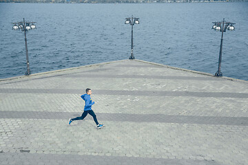 Image showing Man running on city background at morning.