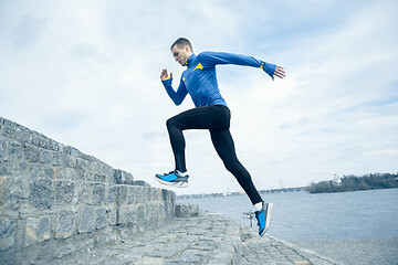 Image showing Man running on city background at morning.