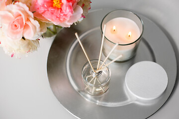 Image showing aroma reed diffuser, candle and flowers on table