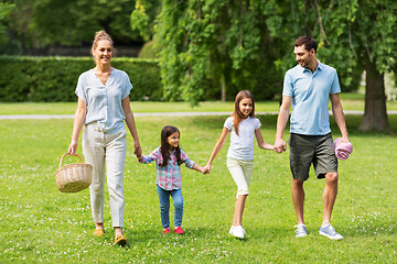 Image showing family with picnic basket walking in summer park