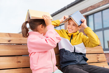 Image showing school children with books having fun outdoors