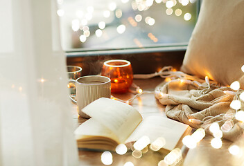 Image showing book and coffee or hot chocolate on window sill