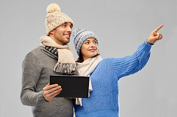 Image showing couple in winter clothes with tablet computer