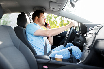 Image showing man driving car and calling on smartphone