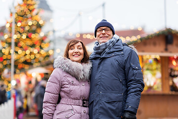 Image showing happy senior couple hugging at christmas market