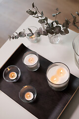 Image showing candles and branches of eucalyptus on table