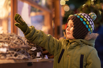 Image showing happy little boy at christmas market in winter