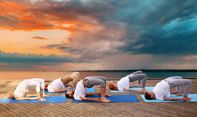 Image showing group of people making yoga exercises outdoors