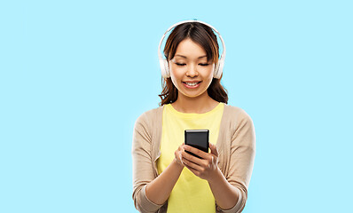 Image showing asian woman in headphones listening to music