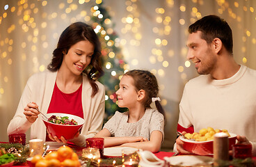 Image showing happy family having christmas dinner at home