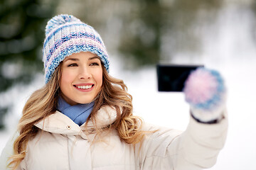 Image showing woman taking selfie by smartphone in winter