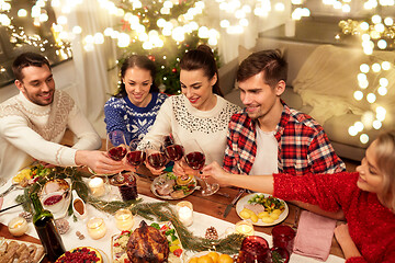 Image showing friends celebrating christmas and drinking wine