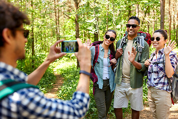 Image showing friends with backpacks being photographed on hike